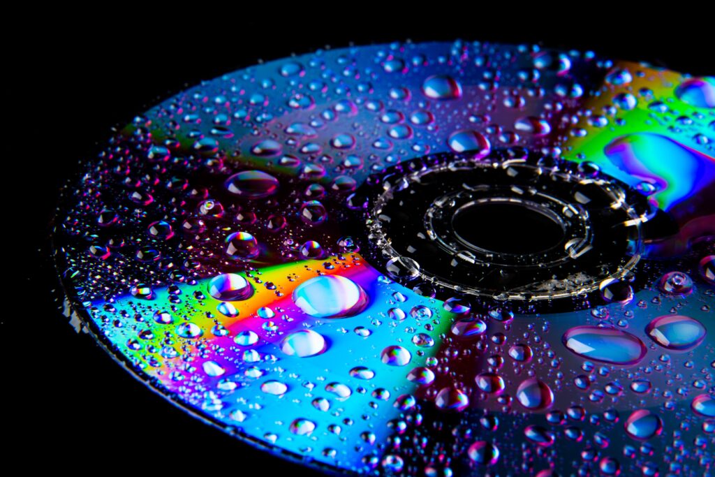 Colorful CD Surface with Water Droplets - Mesmerizing Wallpaper Background