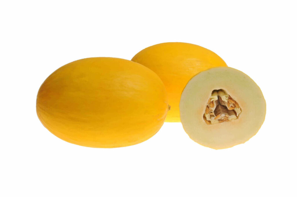 Vibrant canary melons with bright yellow skin and juicy pale interior on white background wallpaper