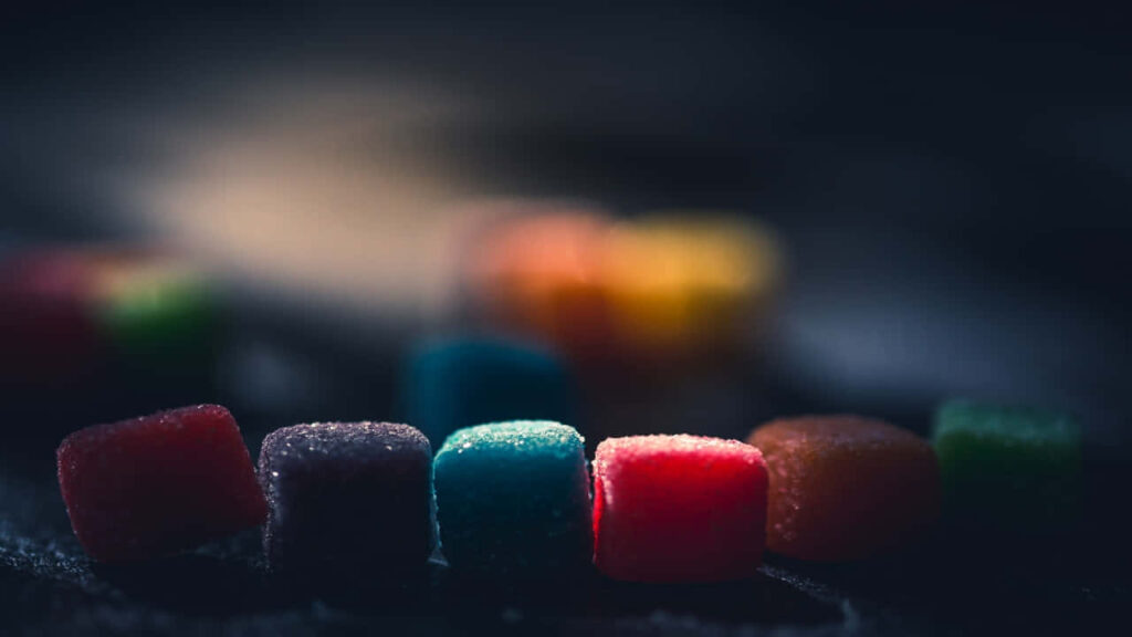 Vibrant Candy Cube Wallpaper: Colorful Delight on Dark Background