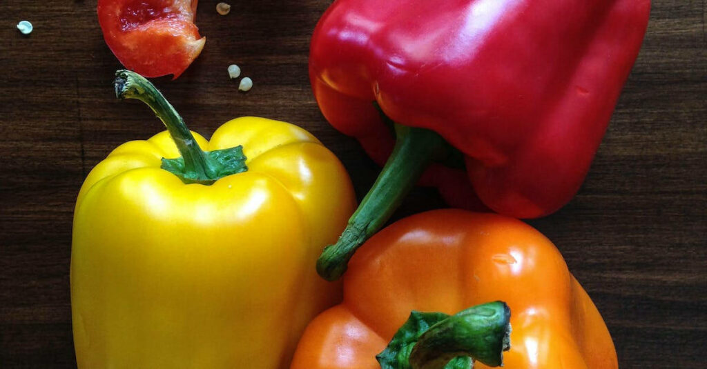 Vibrant Capsicum Close-Up: Colorful Red, Yellow & Orange Wallpaper