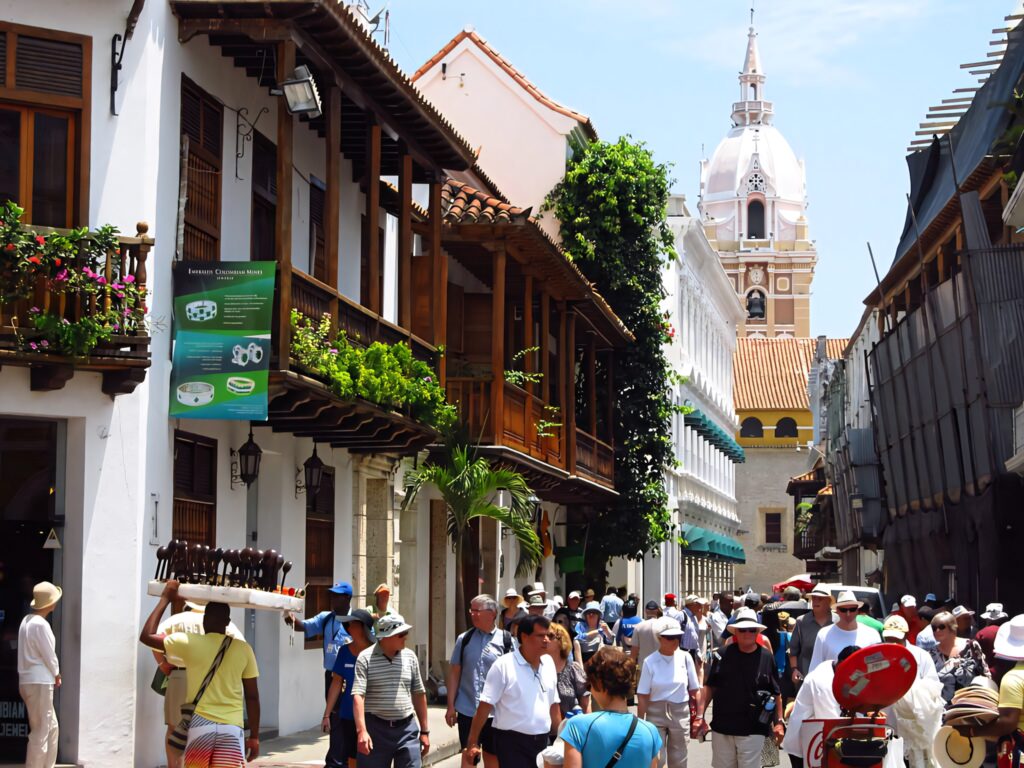 Tourists exploring colorful colonial streets of historic Cartagena Colombia with iconic dome view Wallpaper