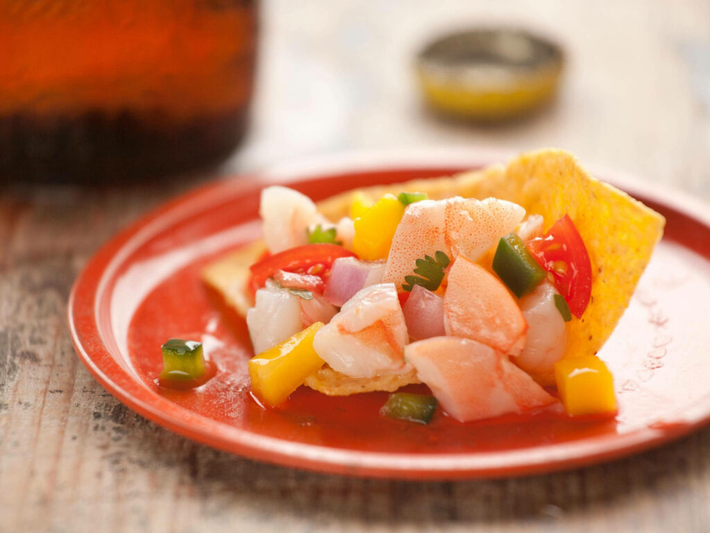 Close-up of colorful ceviche tostadas with fresh seafood mango jalapeño on red plate wallpaper