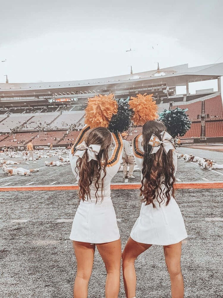 Cheerleaders in Action: Dynamic Team Spirit Wallpaper Background