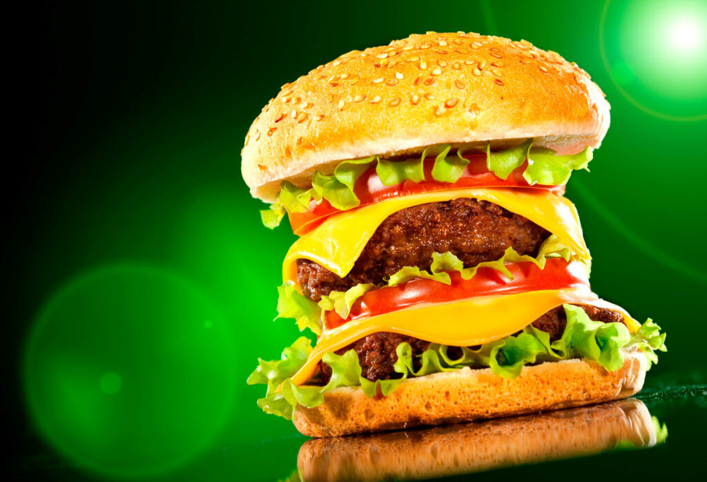 Vibrant Cheeseburger Wallpaper: Close-Up with Greens & Juicy Layers