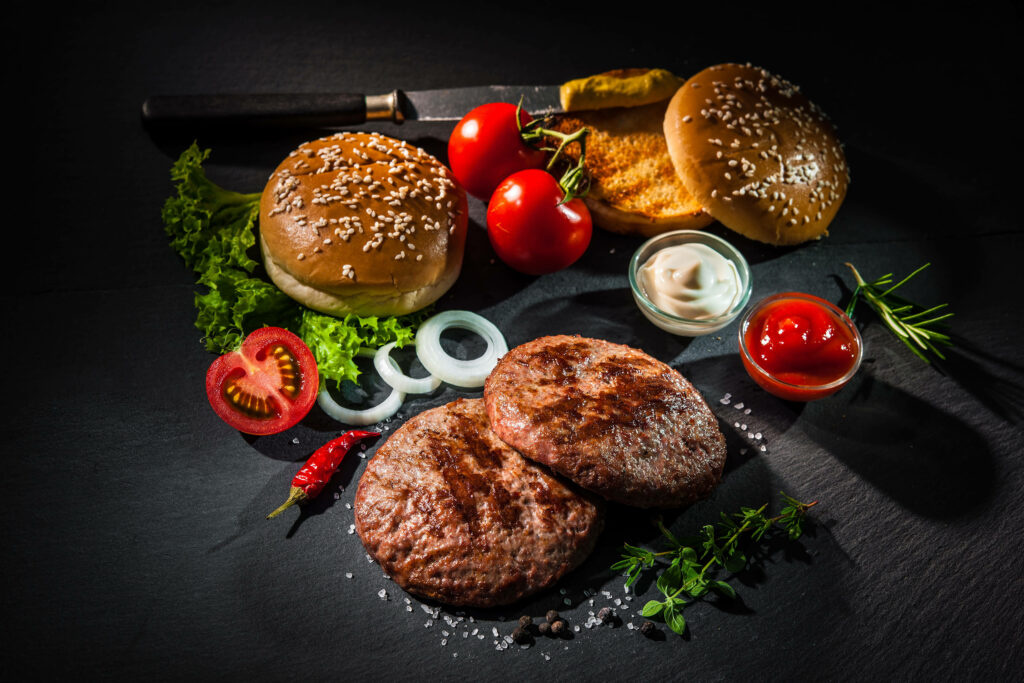 Vibrant Cheeseburger Ingredients Wallpaper on Dark Background