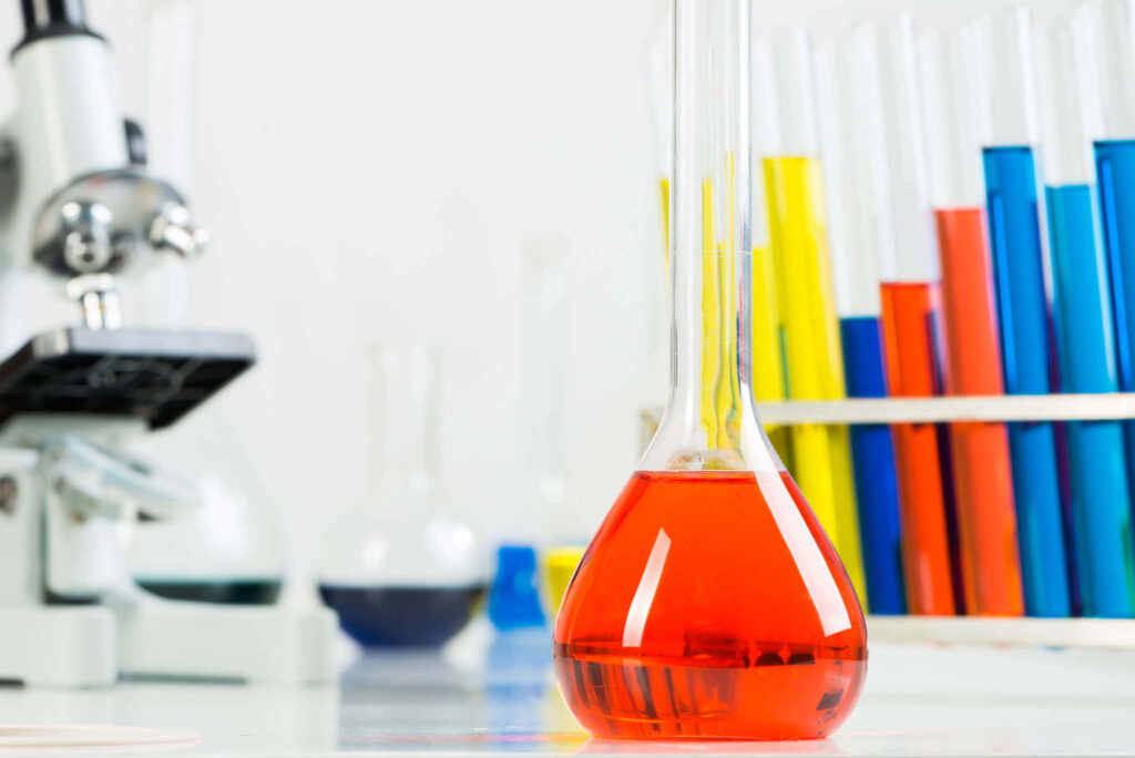 Vibrant chemistry lab scene with red flask and colorful test tubes in modern clean setting Wallpaper