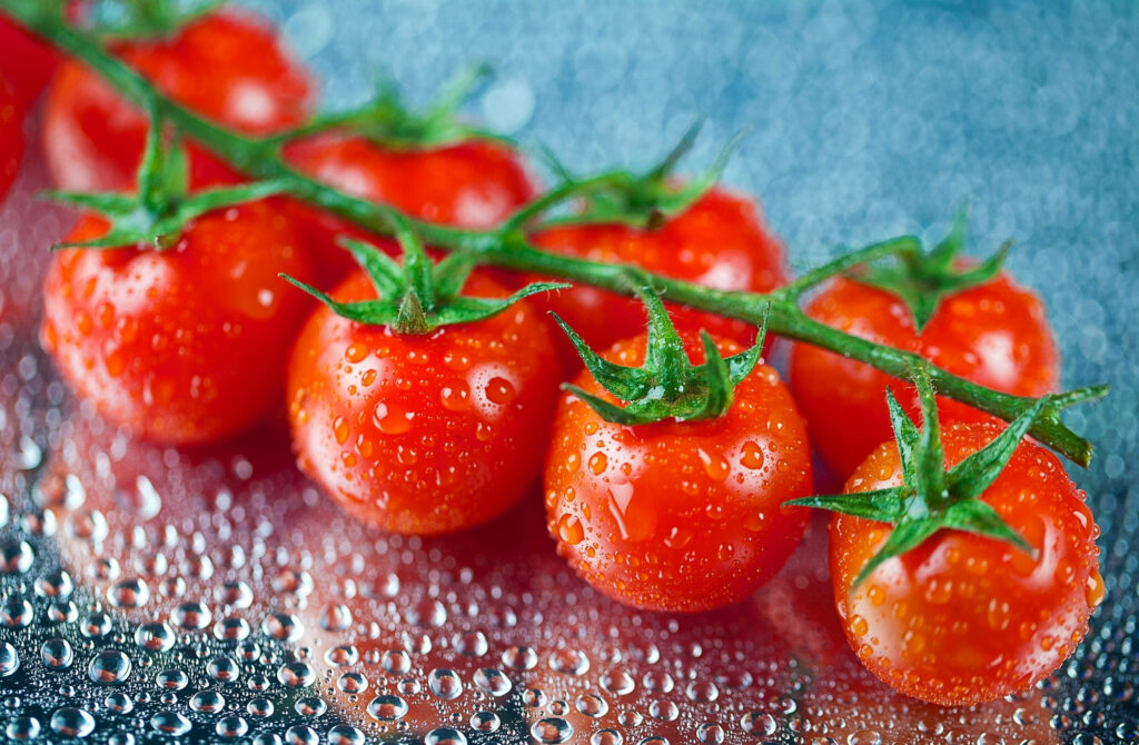 Juicy Red Cherry Tomatoes Wallpaper - Fresh & Reflective Background