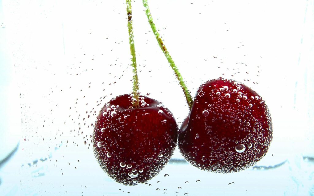 Refreshing Cherry Wallpaper: Ripe Cherries in Bubbles Underwater
