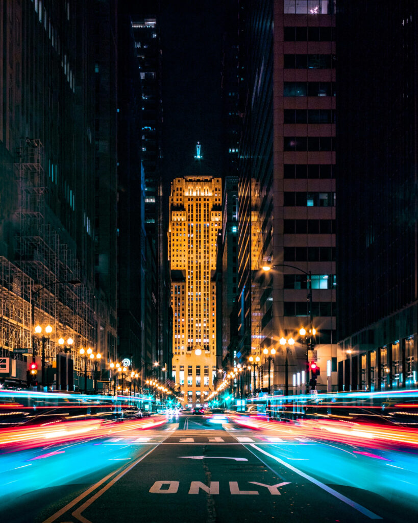 Chicago skyline night cityscape with vibrant light trails and glowing art deco building wallpaper