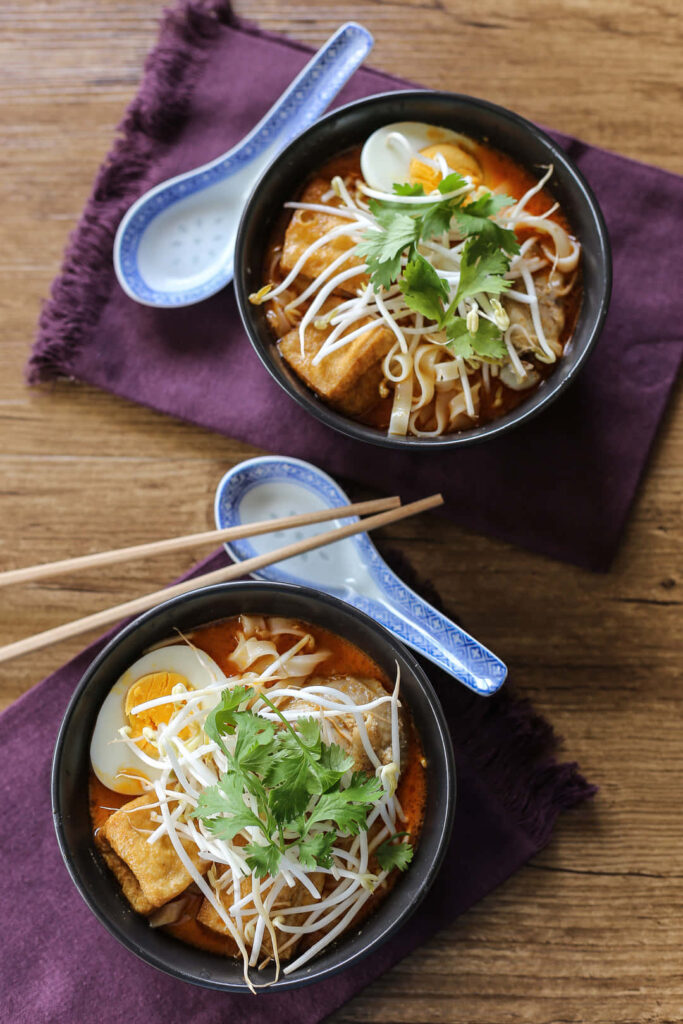 Vibrant Chicken Curry Laksa Wallpaper with Rustic Table Setting