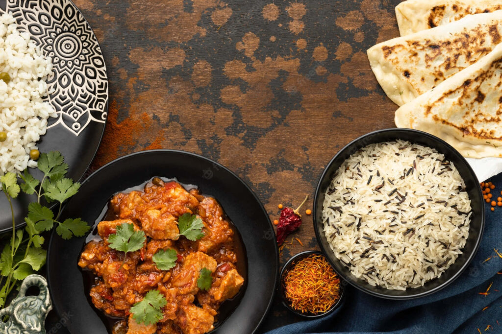Vibrant Chicken Tikka Masala Wallpaper with Rice and Naan Décor