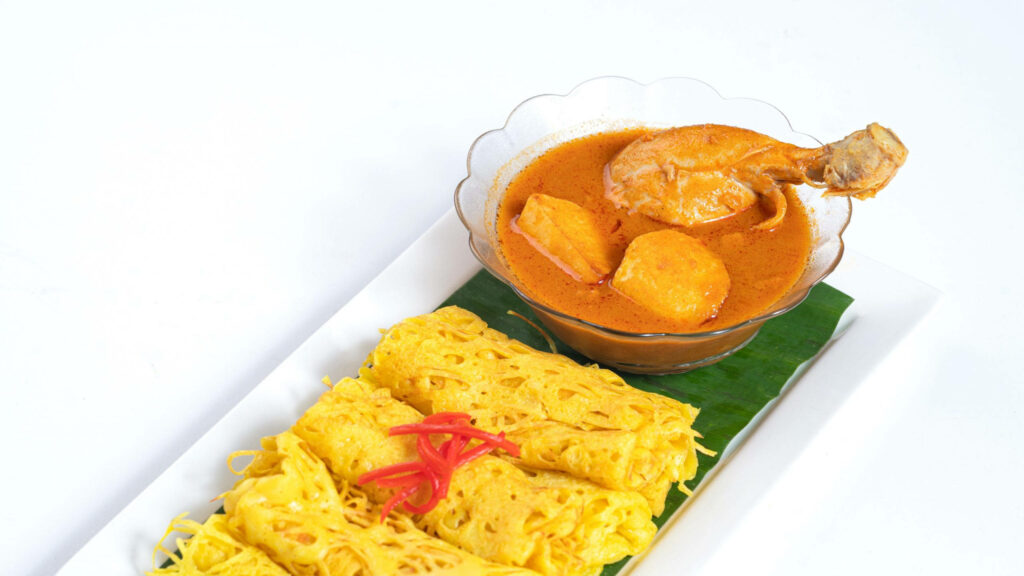 Vibrant Chicken Curry with Roti Jala - Delicious Wallpaper Background