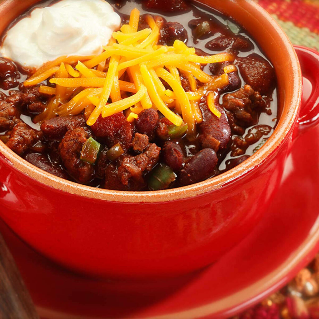Chili Con Carne in Red Bowl: Hearty Meal Wallpaper Background