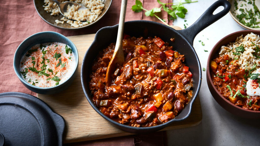Vibrant Chili con Carne Wallpaper: Skillet with Rice & Yogurt