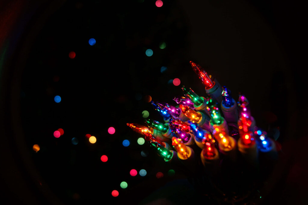 Vibrant Christmas Lights: Capturing Holiday Magic Against Dark Background Wallpaper