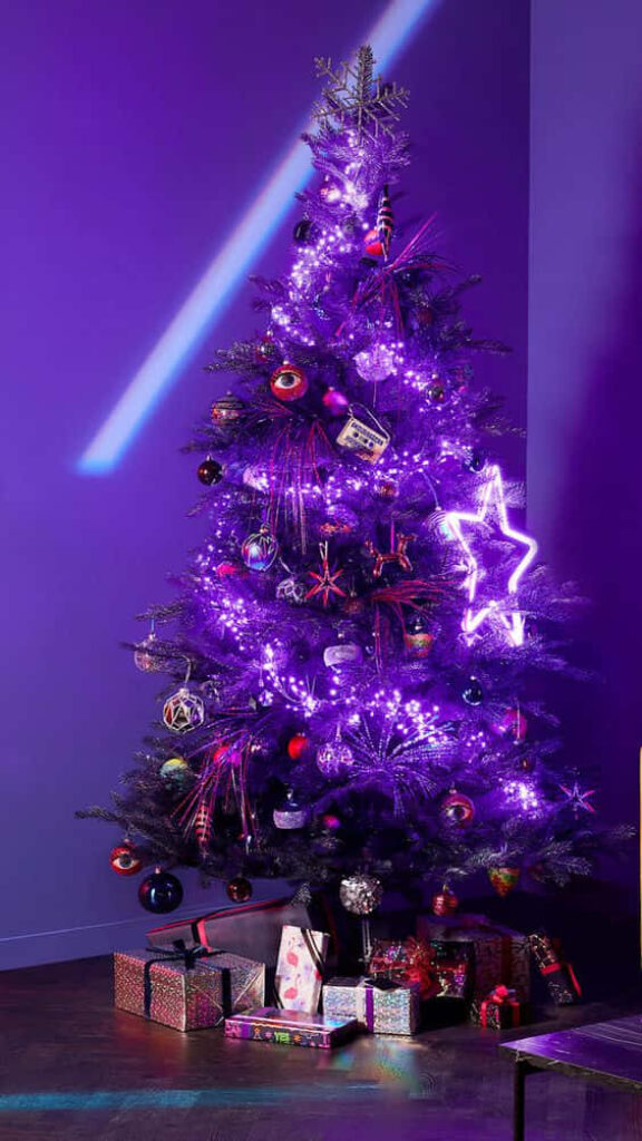 Vibrant Christmas Tree with Purple Lights and Ornaments Background Wallpaper
