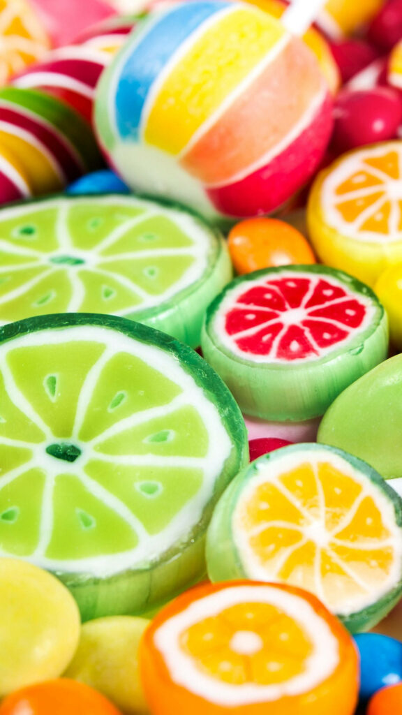 Colorful citrus candy wallpaper with glossy fruit slice designs in green yellow and red tones