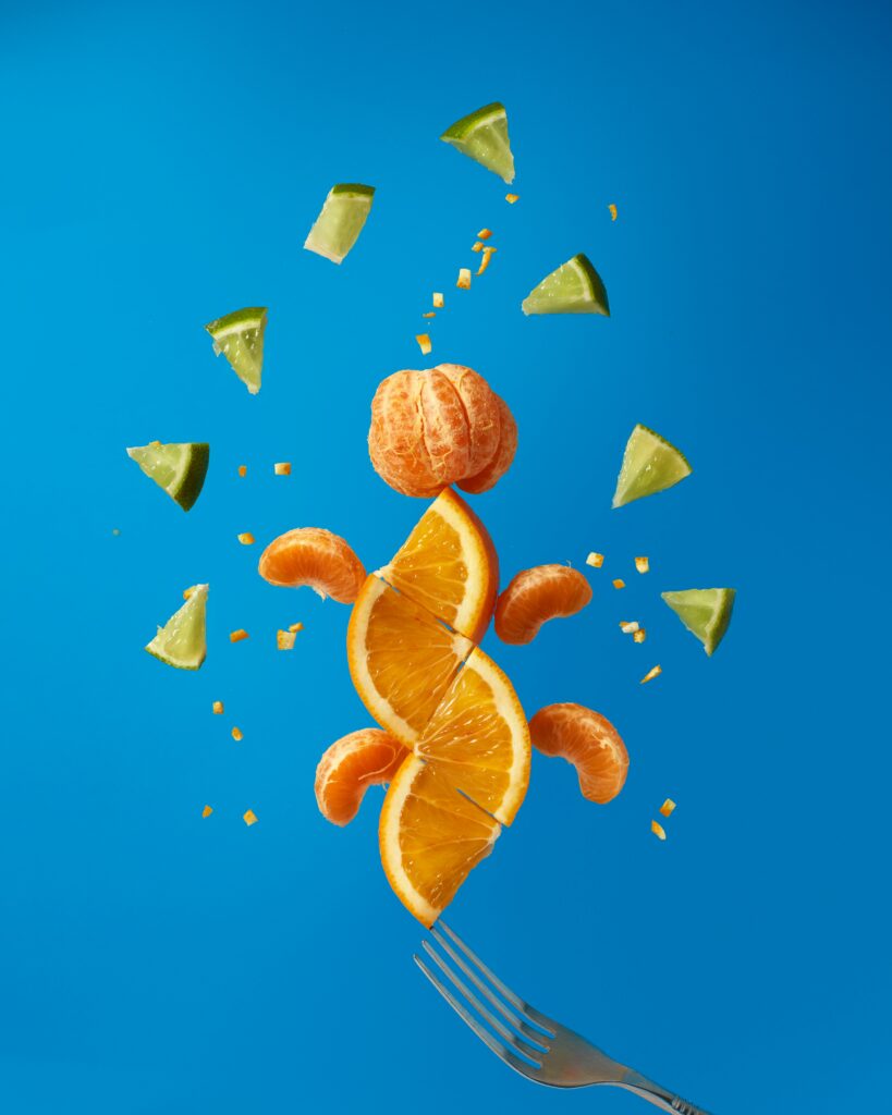 Vibrant Citrus Fruits Wallpaper: Fresh Design on Bright Blue Background