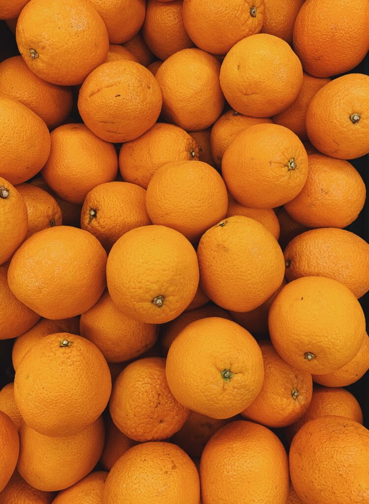 Vibrant Close-Up Wallpaper of Fresh Oranges for Tropical Vibes