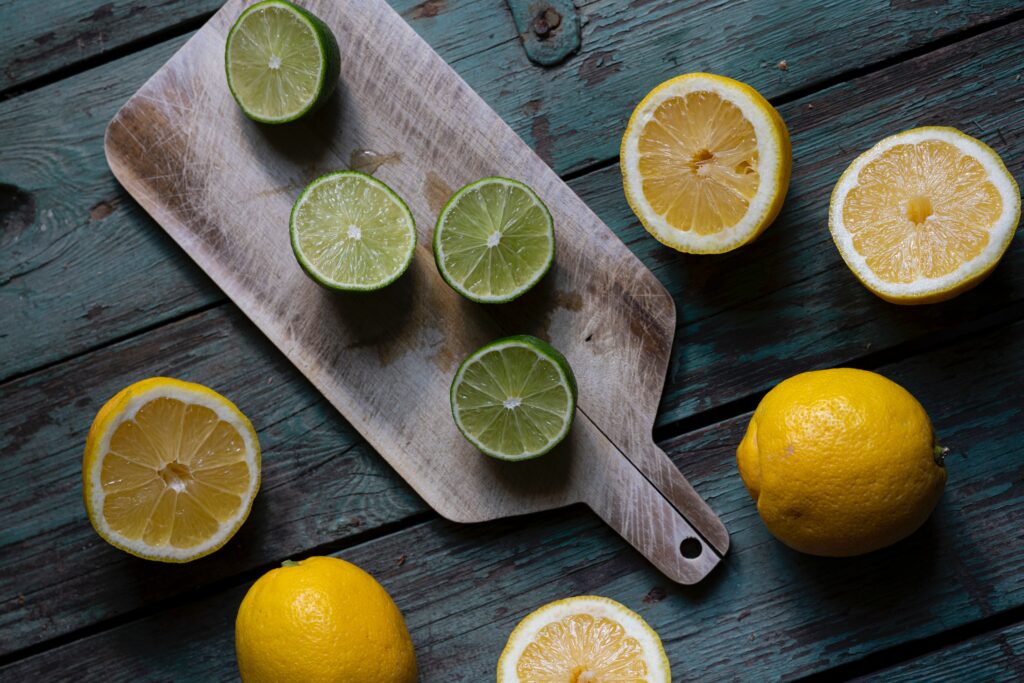 Vibrant Citrus Wallpaper: Fresh Limes & Lemons on Rustic Wood