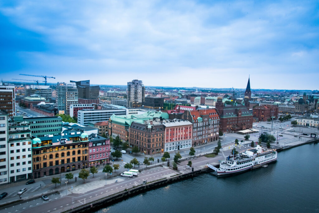 Vibrant City Aerial View Wallpaper: Historic Meets Modern by Water