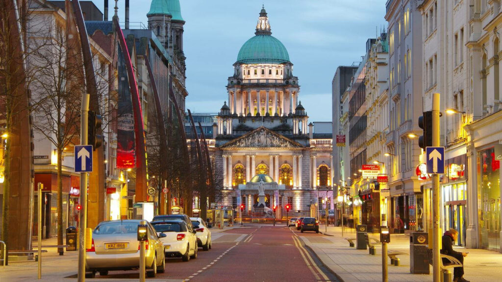Vibrant City Street Wallpaper: Historic Dome Building & Illuminated Shops