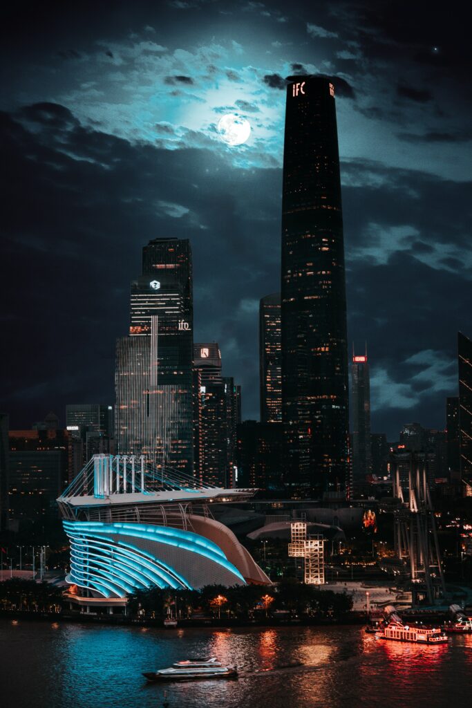 Vibrant Cityscape Night Wallpaper: Modern Lights & Moon Reflection