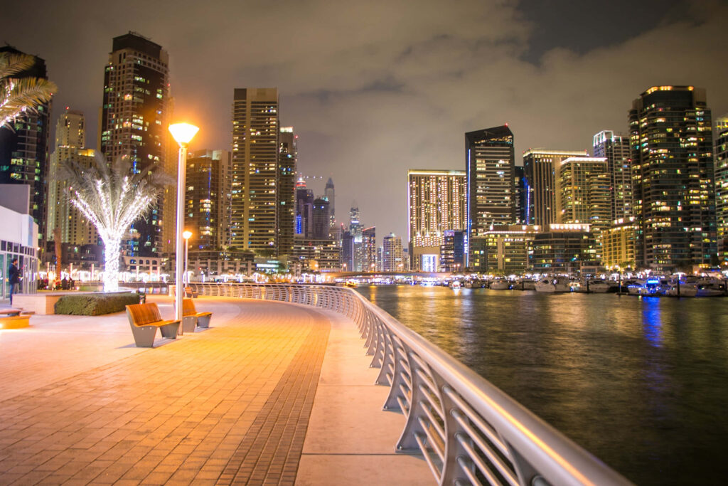 Vibrant Night Cityscape Wallpaper: Modern Skyscrapers & Reflections