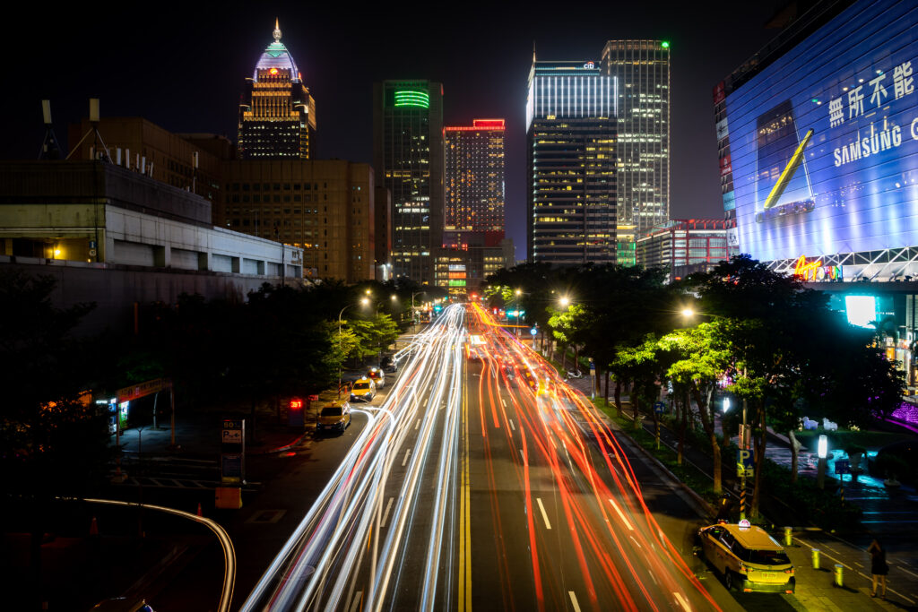 Vibrant Night Cityscape Wallpaper: Colorful Light Trails & Skyscrapers