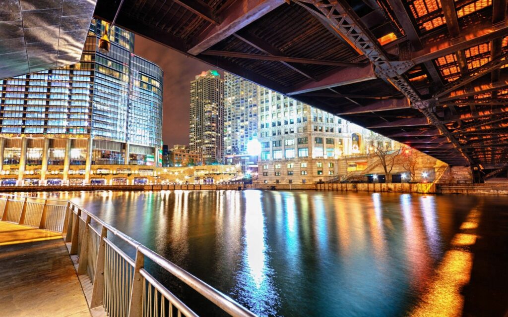Vibrant Cityscape Night Wallpaper with Illuminated Bridge & River