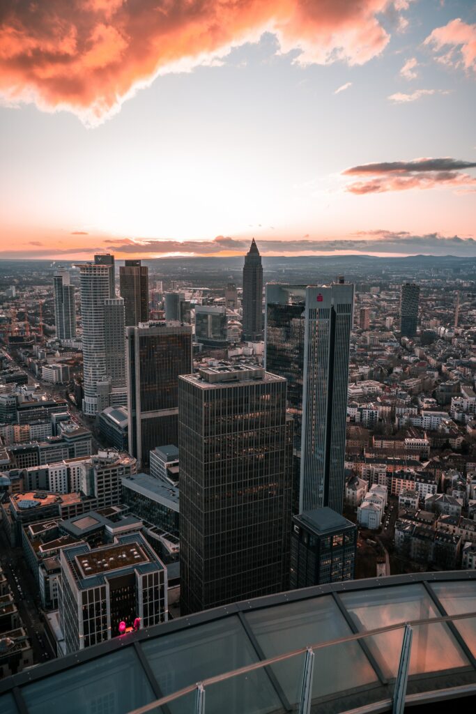 Vibrant Cityscape Sunset Wallpaper: Modern Buildings & Glowing Sky
