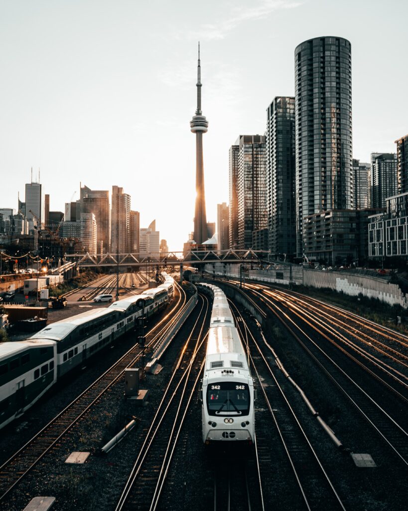 Vibrant Sunset Cityscape Wallpaper: Train Amidst Modern High-Rises