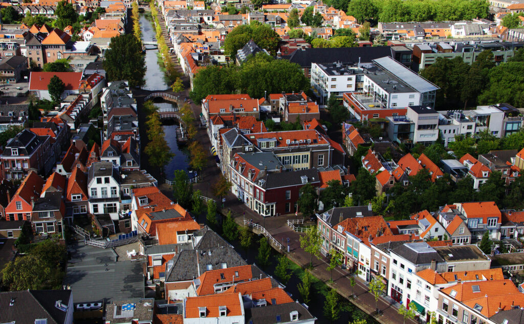 Charming Cityscape Wallpaper: Vibrant Aerial View of Red-Roofed Town