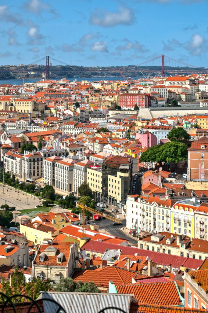 Vibrant Cityscape Wallpaper: Colorful Homes & Iconic Bridge Design