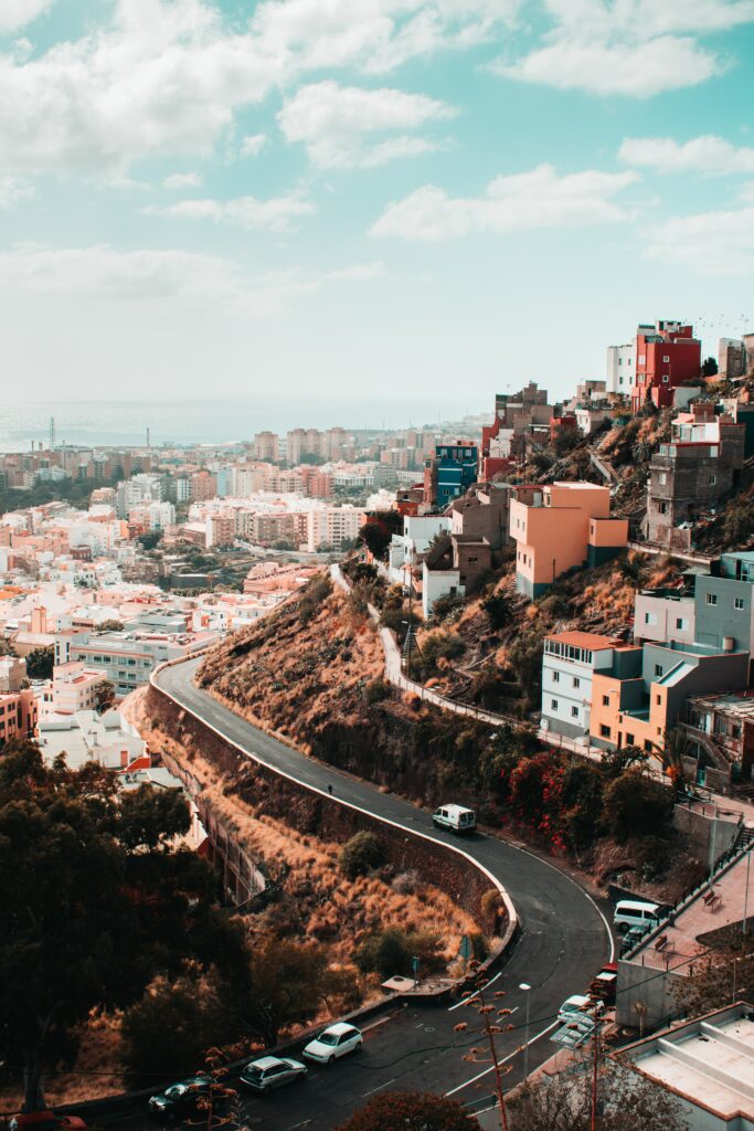Vibrant Cityscape Wallpaper: Colorful Houses & Winding Road Charm