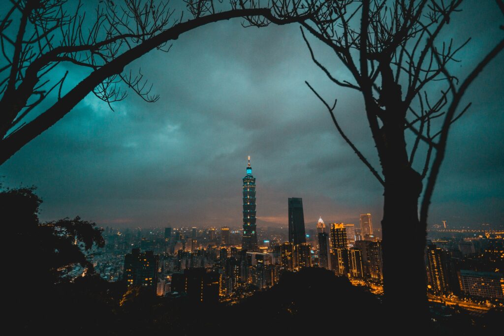 Vibrant Cityscape Wallpaper: Evening Metropolis with Tower & Thunderclouds