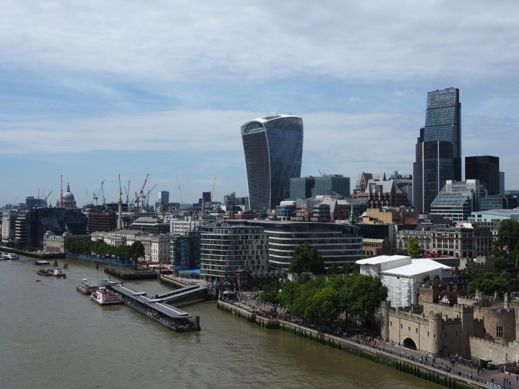 Vibrant Cityscape Wallpaper: Modern Architecture & River Pier Scene