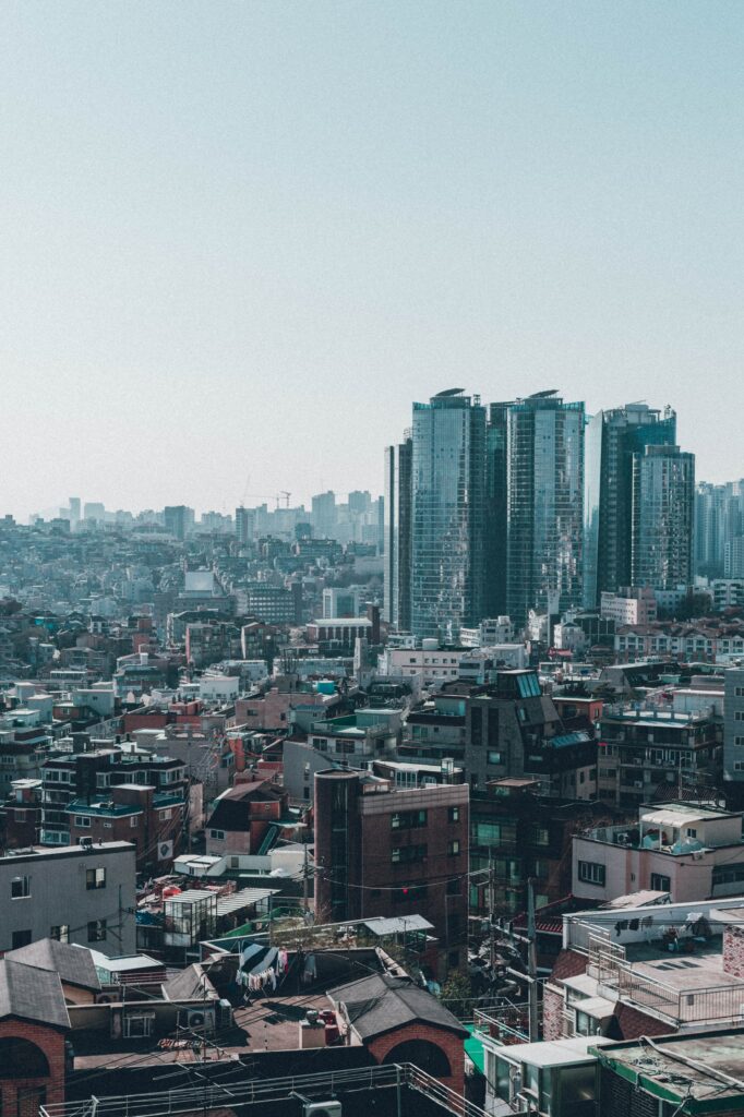 Vibrant Cityscape Wallpaper: Modern Skyscrapers & Traditional Rooftops