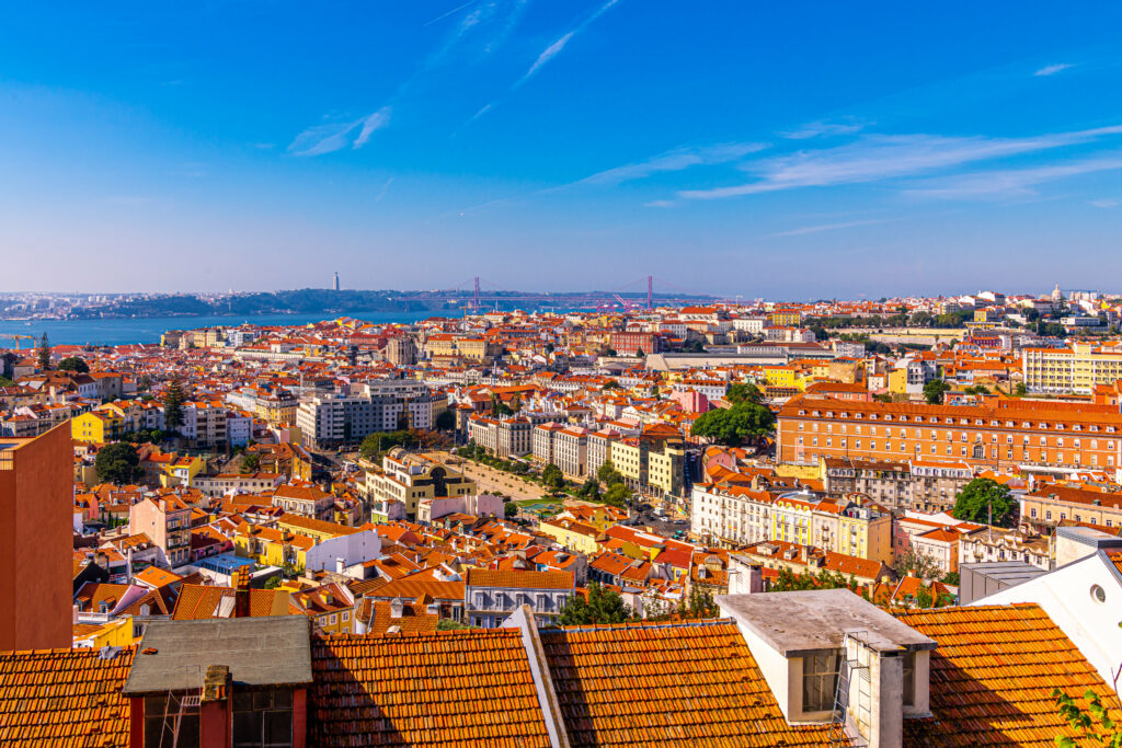 Vibrant Cityscape Wallpaper: Terracotta Rooftops & Serene Waters