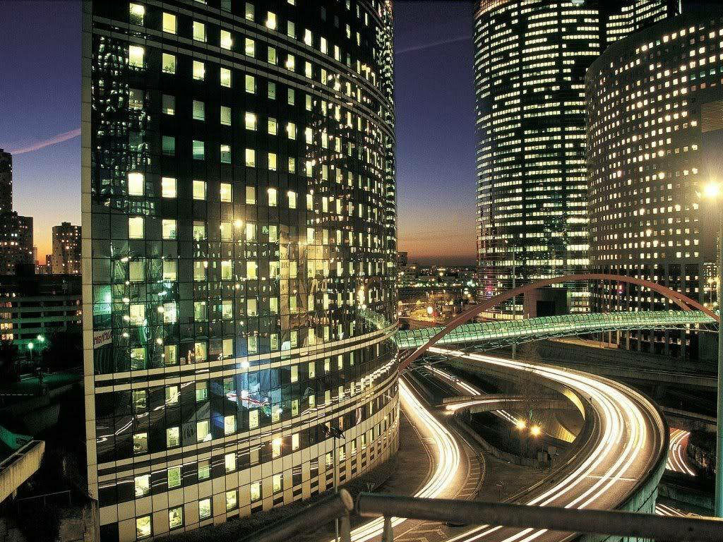 Vibrant Cityscape Wallpaper: Illuminated Towers & Twilight Highway