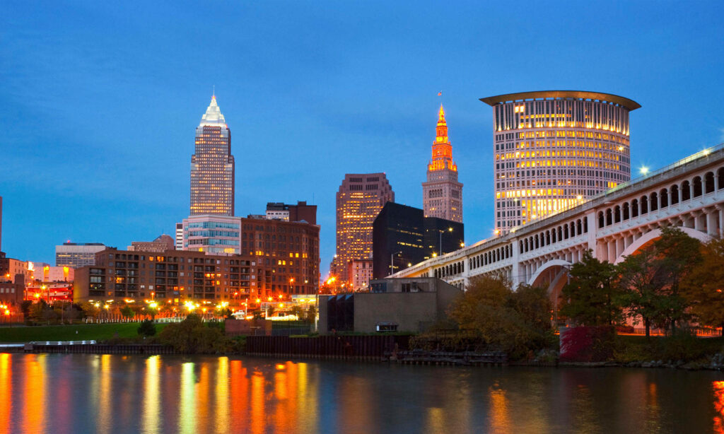 Vibrant Cleveland Skyline at Night: Illuminated Wallpaper Background