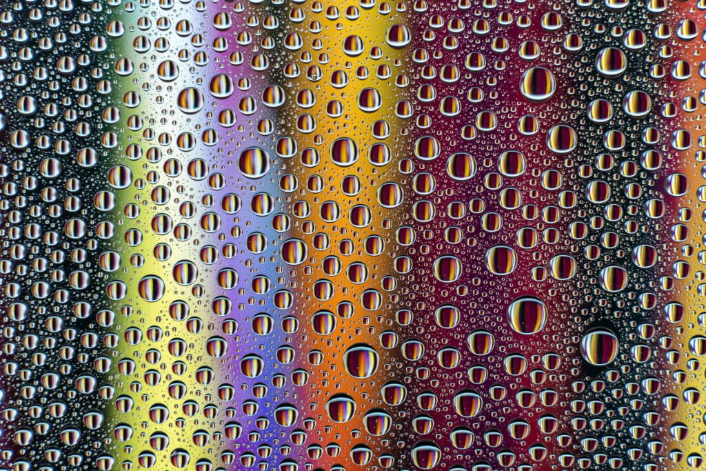 Vibrant Water Droplets: Colorful Close-Up Wallpaper Background