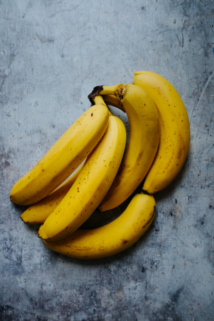Vibrant Yellow Bananas Close-Up | Textured Surface Wallpaper