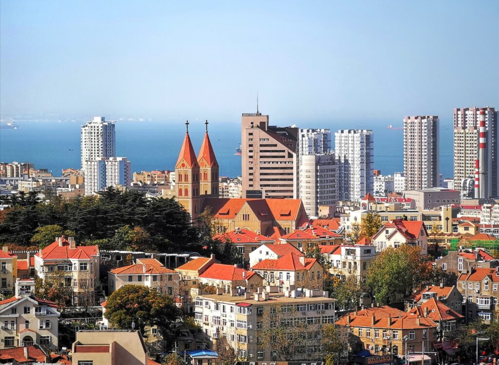 Vibrant Coastal City Wallpaper: Red Rooftops & Serene Blue Coast