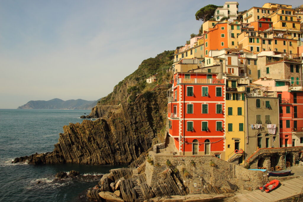 Vibrant Coastal Town Wallpaper: Colorful Cliffs & Serene Sea Views