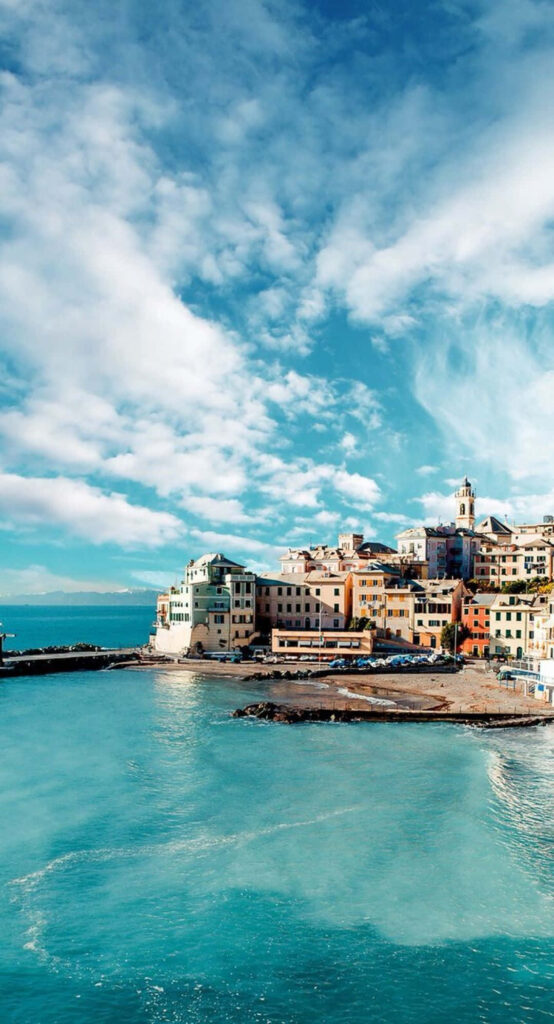 Vibrant Coastal Townscape Wallpaper: Colorful Buildings by Turquoise Sea