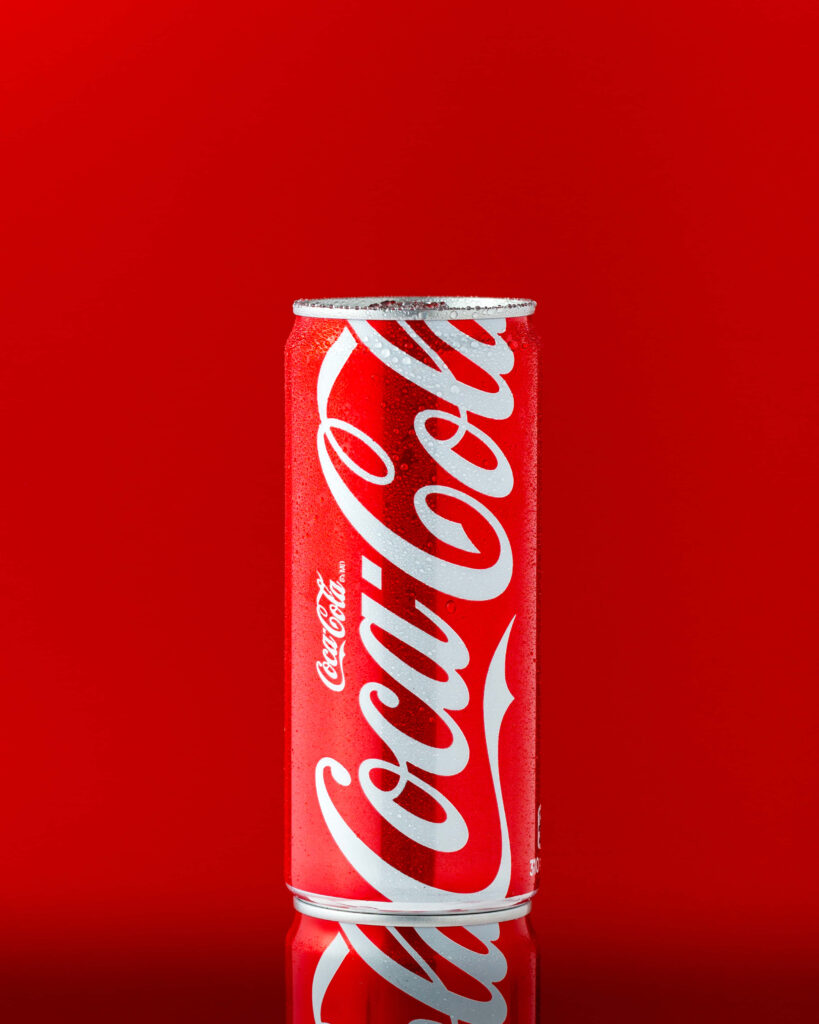 Vibrant Coca Cola wallpaper with tall Coke can red background iconic white logo condensation
