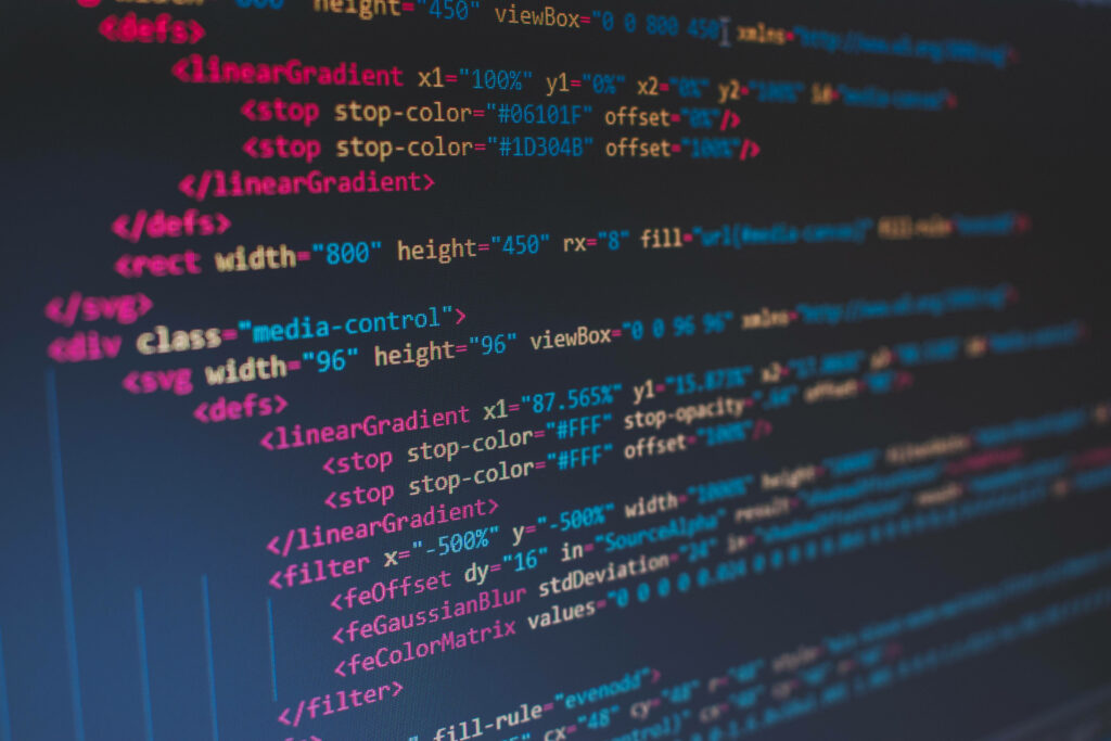 Technicolor Coding: Vibrant Letters on a Blurred Canvas Wallpaper