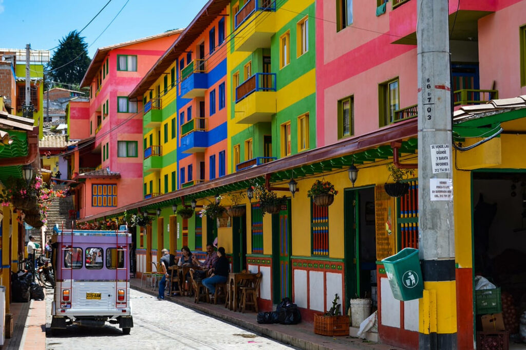 Colorful street in Colombia with vibrant buildings showcasing authentic culture and charm wallpaper
