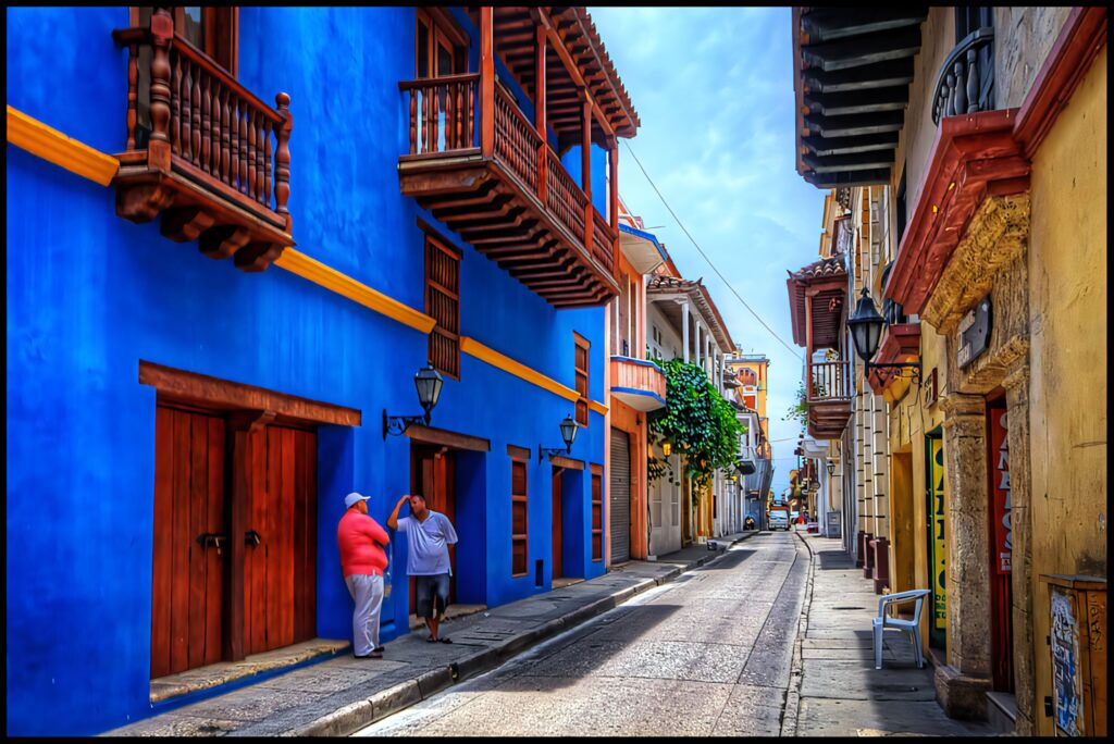 Colorful colonial buildings with wooden balconies on a vibrant street in Cartagena Colombia wallpaper